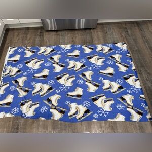 Sewing/fleece/ice skating fabric.  Blue background with white figure skates